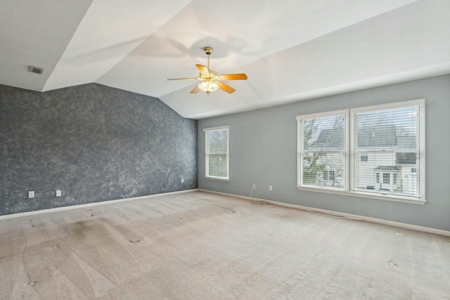 carpeted spare room with lofted ceiling and ceiling fan