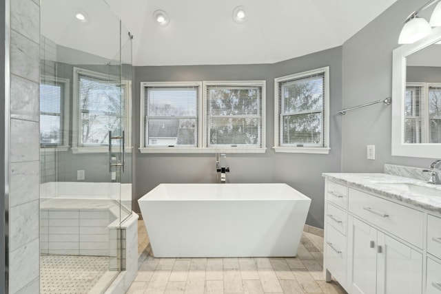 bathroom featuring vanity and shower with separate bathtub