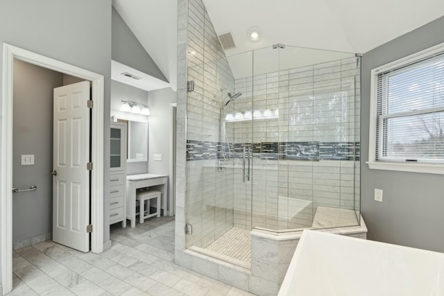 bathroom with lofted ceiling and a shower with door