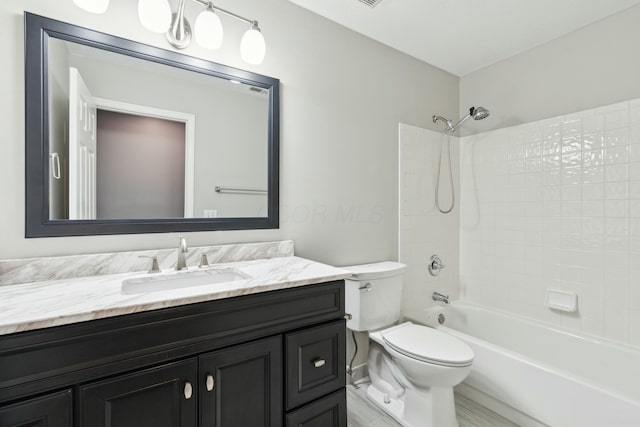 full bathroom with vanity, toilet, and washtub / shower combination