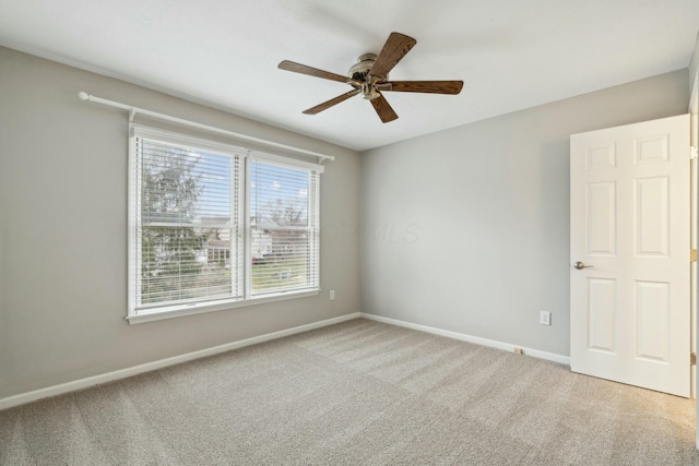 spare room with ceiling fan and carpet flooring