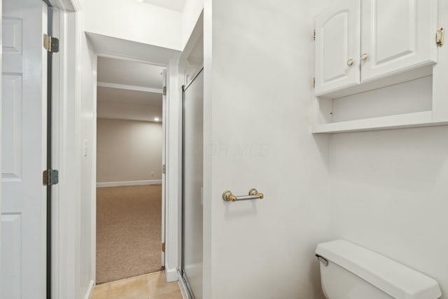 bathroom with tile patterned floors and toilet