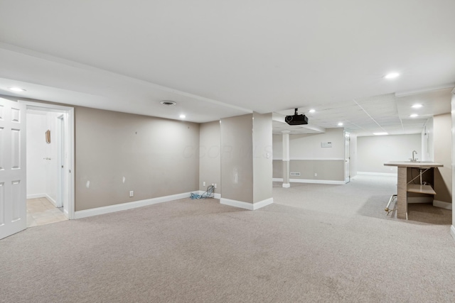 basement featuring light carpet