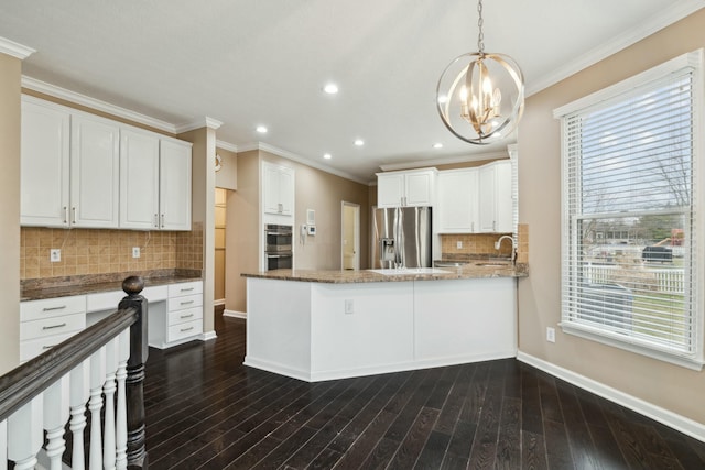 kitchen with pendant lighting, crown molding, stainless steel fridge with ice dispenser, and white cabinets