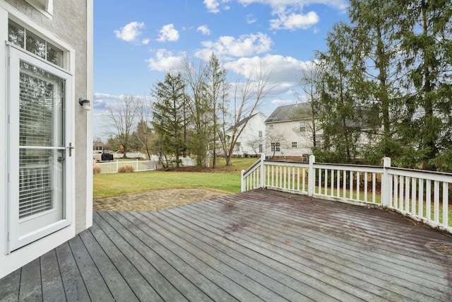 wooden deck with a lawn