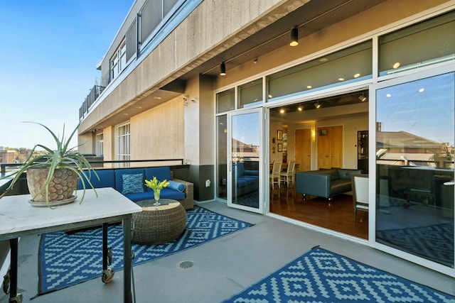 view of patio featuring a balcony and an outdoor living space