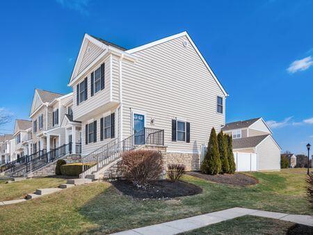 view of side of home with a yard