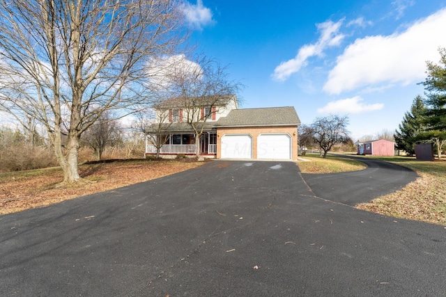 view of front of house featuring a garage and a porch