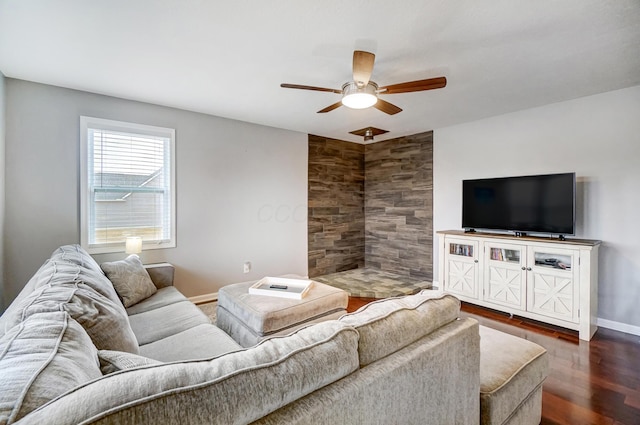 living room with dark wood-type flooring and ceiling fan