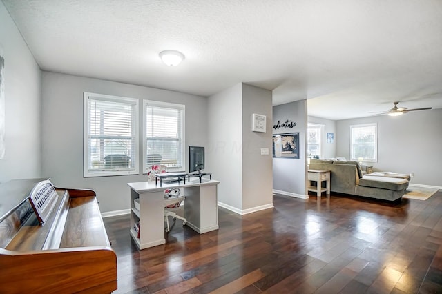 office area with ceiling fan, dark hardwood / wood-style flooring, and a textured ceiling