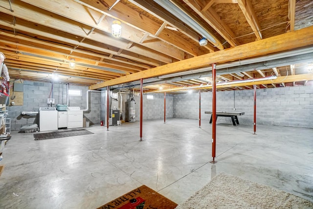 basement with heating unit, gas water heater, and washer and clothes dryer