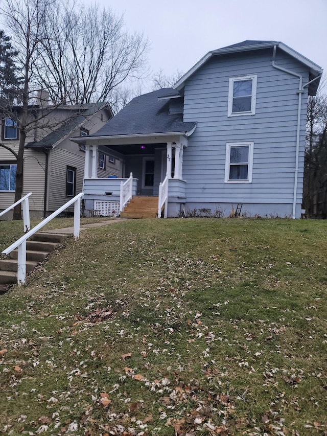 view of front of property with a porch and a front lawn