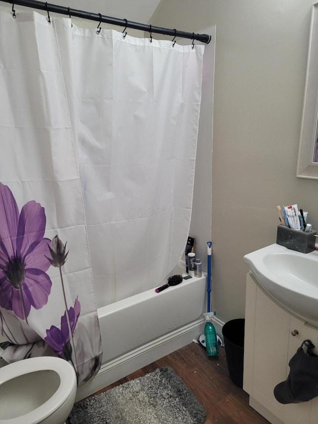 full bathroom featuring wood-type flooring, toilet, vanity, and shower / bath combo with shower curtain