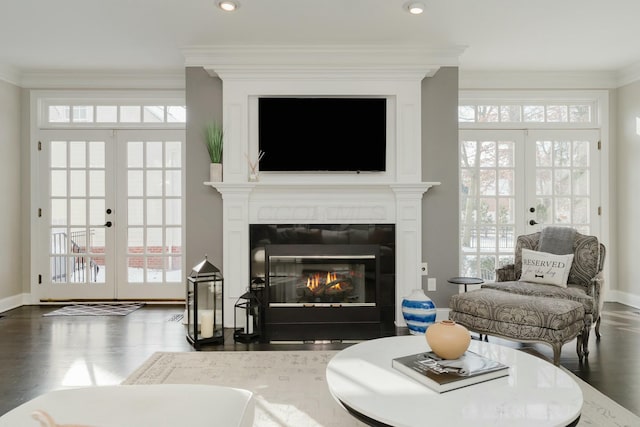 living room with crown molding, dark hardwood / wood-style floors, and french doors