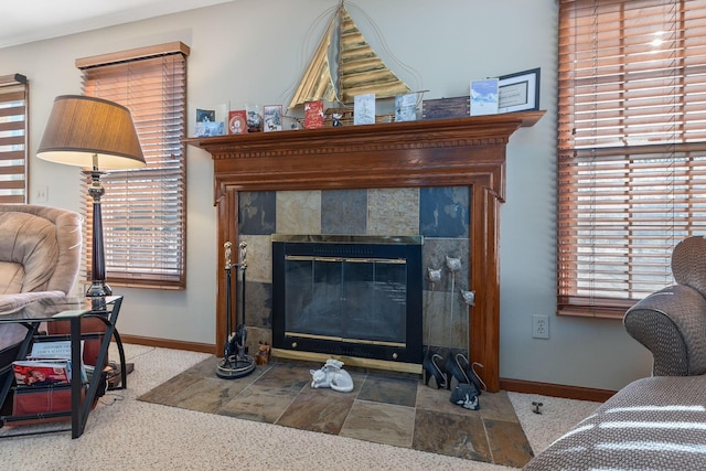 living room featuring a tiled fireplace