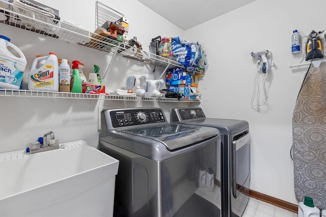 washroom with sink and washer and dryer