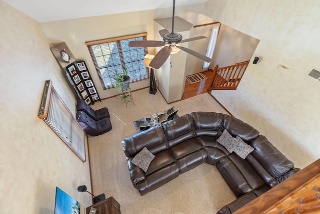 living room with high vaulted ceiling, carpet floors, and ceiling fan