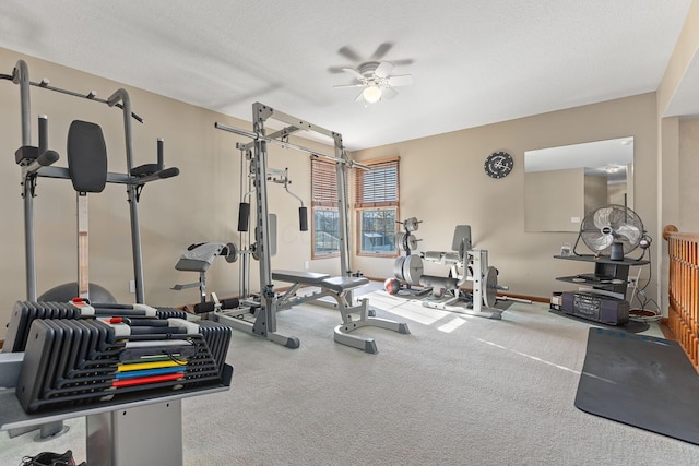 workout room with ceiling fan, carpet, and a textured ceiling