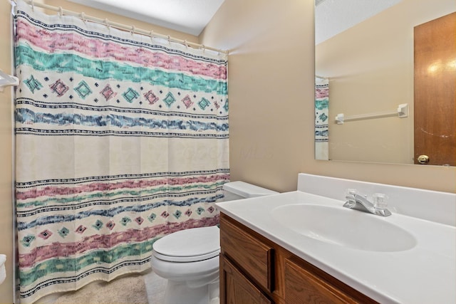 bathroom featuring vanity, toilet, and curtained shower