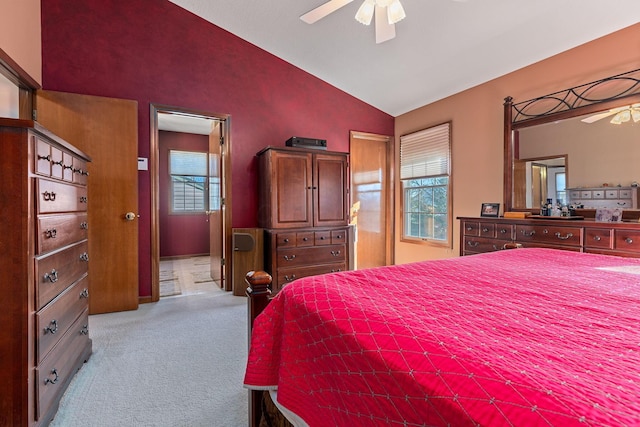 bedroom featuring lofted ceiling, light colored carpet, and ceiling fan