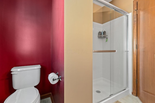 bathroom featuring walk in shower and toilet