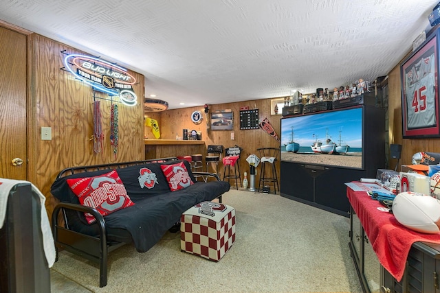 carpeted living room featuring wooden walls and a textured ceiling