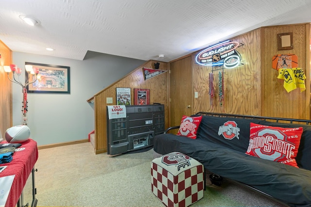 living room featuring a textured ceiling and wood walls