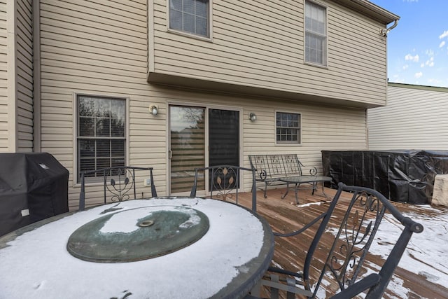 snow covered deck featuring grilling area