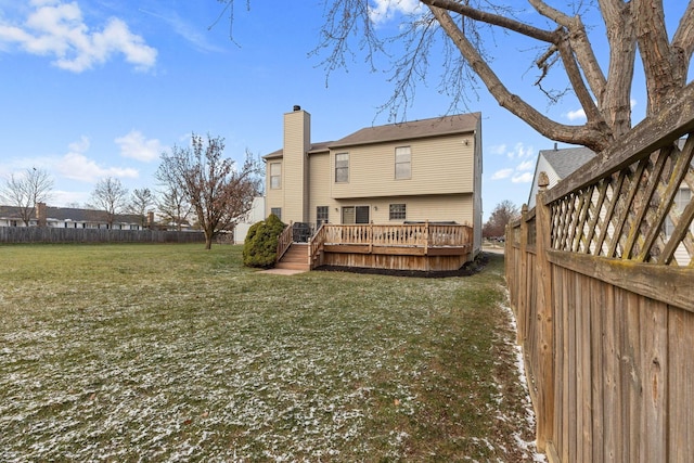 back of house with a deck and a lawn