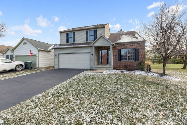 front facade featuring a garage and a front lawn