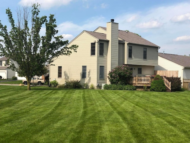 5037 Langcroft Dr, Hilliard, OH 43026 - back of house featuring a lawn, a wooden deck, and a chimney