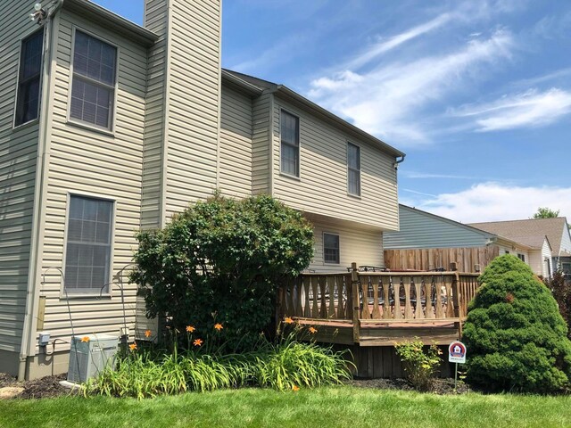 5037 Langcroft Dr, Hilliard, OH 43026 - rear view of house with a deck and a chimney