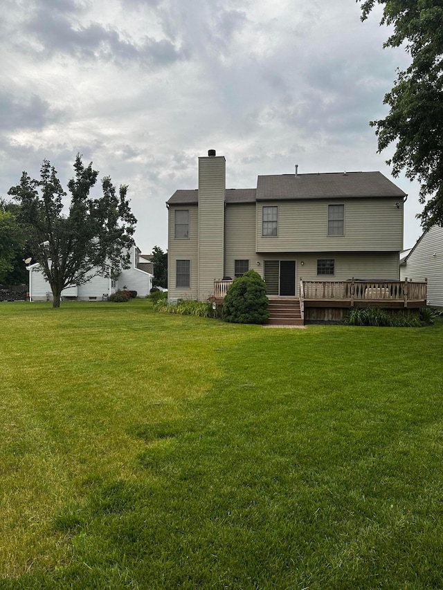 5037 Langcroft Dr, Hilliard, OH 43026 - back of house featuring a chimney, a deck, and a lawn