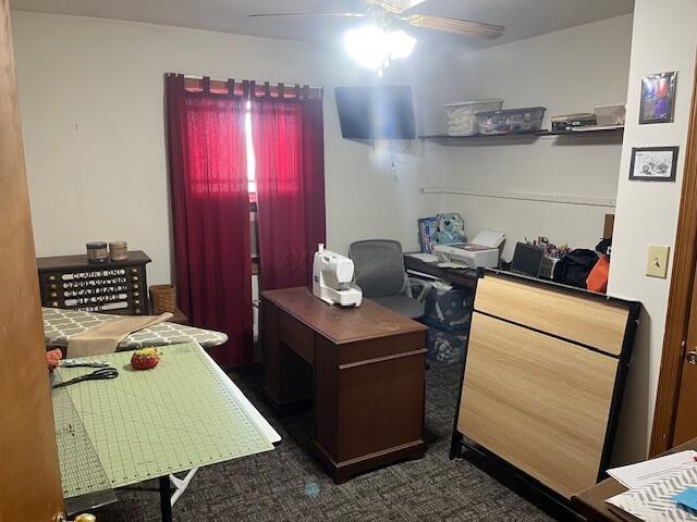 carpeted office with ceiling fan