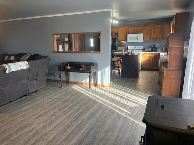 living room with crown molding and dark hardwood / wood-style floors