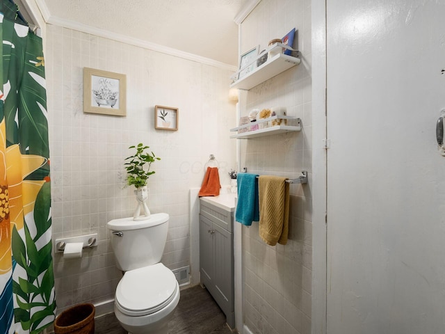 bathroom with crown molding, curtained shower, and toilet