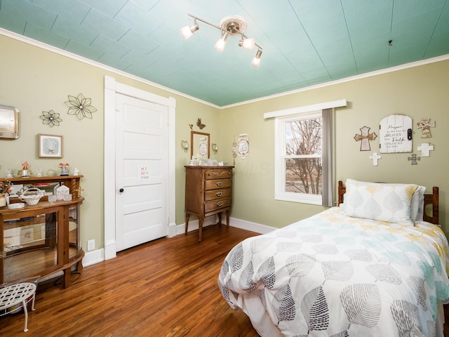 bedroom with crown molding and dark hardwood / wood-style floors