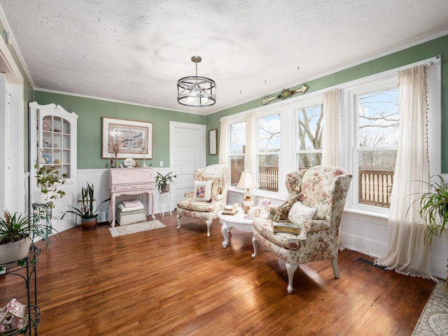 sunroom / solarium featuring an inviting chandelier