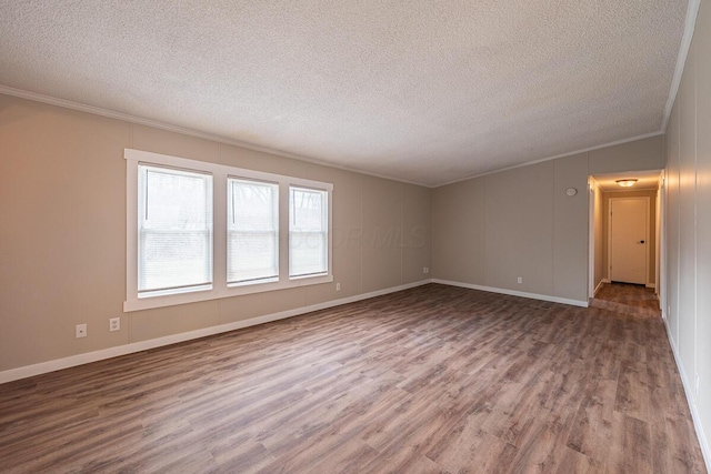 unfurnished room with hardwood / wood-style flooring, crown molding, and a textured ceiling