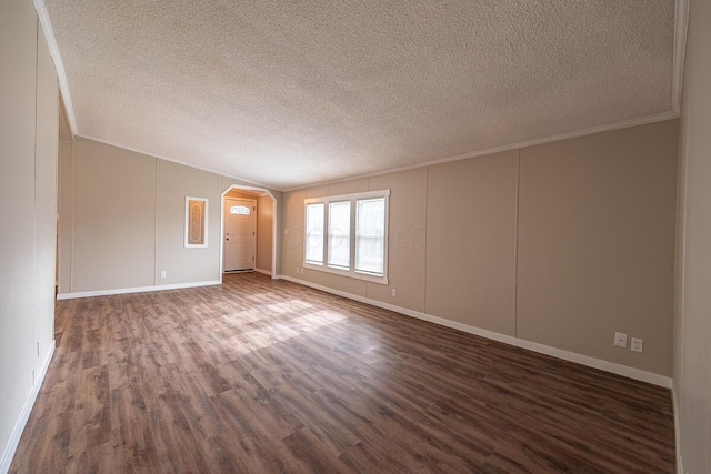 spare room with ornamental molding, dark hardwood / wood-style flooring, and a textured ceiling