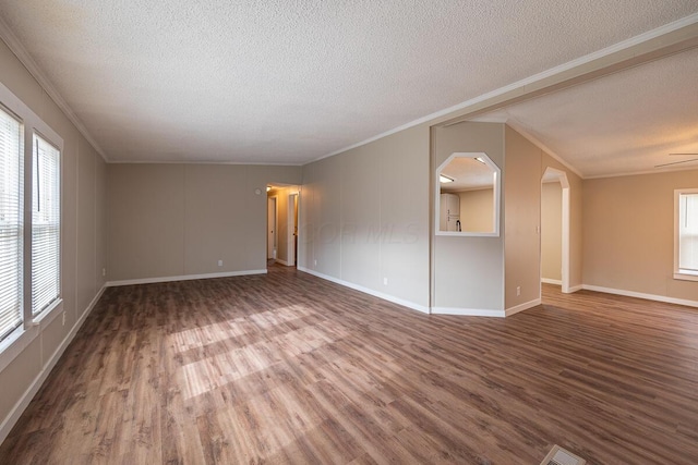 spare room featuring ornamental molding, hardwood / wood-style floors, and a textured ceiling