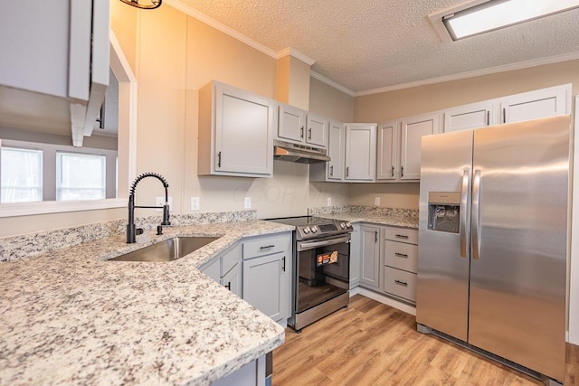 kitchen featuring sink, stainless steel appliances, light stone counters, ornamental molding, and light hardwood / wood-style floors