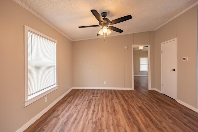 unfurnished room featuring crown molding, dark hardwood / wood-style floors, ceiling fan, and a textured ceiling