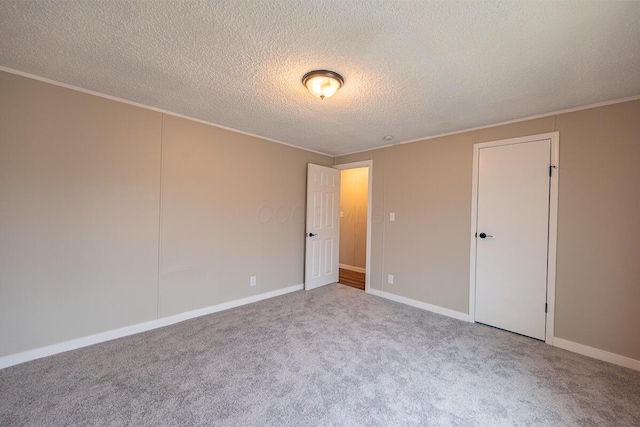 empty room with a textured ceiling and carpet flooring