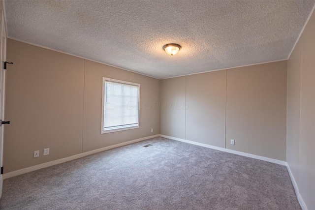 carpeted empty room with a textured ceiling