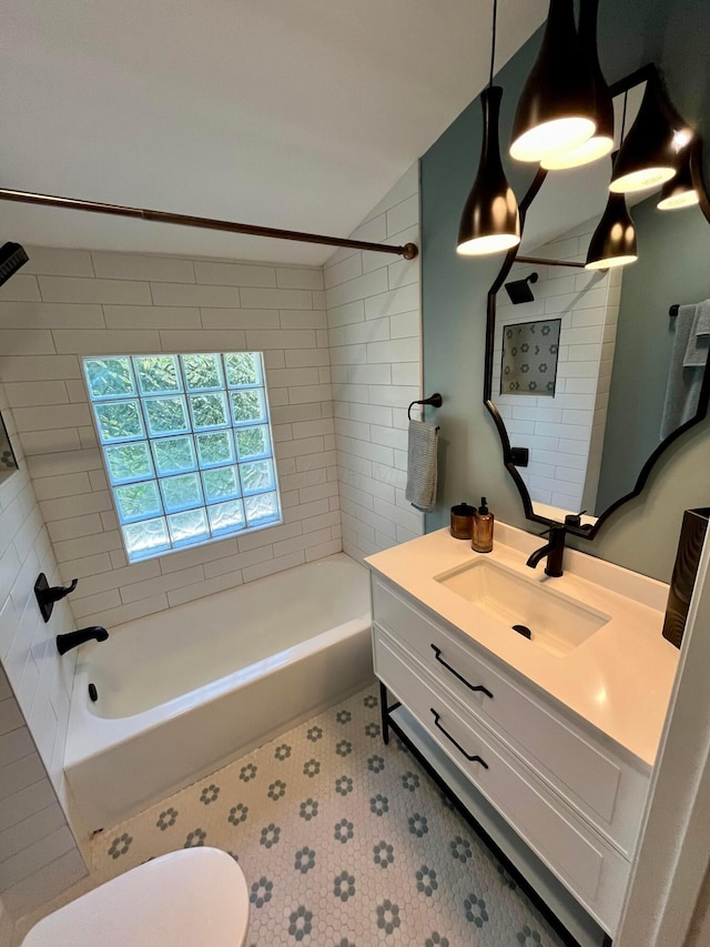 full bathroom featuring vanity, toilet, and tiled shower / bath combo