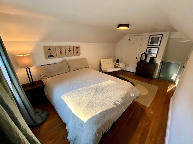 bedroom featuring lofted ceiling and dark hardwood / wood-style floors