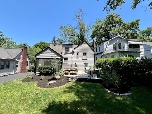 rear view of property with a gazebo, a yard, and a patio area