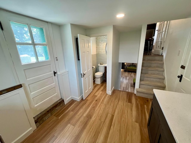 bathroom with hardwood / wood-style flooring and toilet