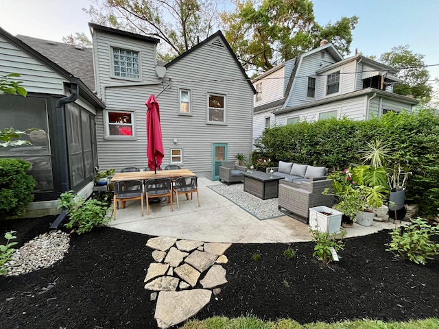 back of house with outdoor lounge area and a patio